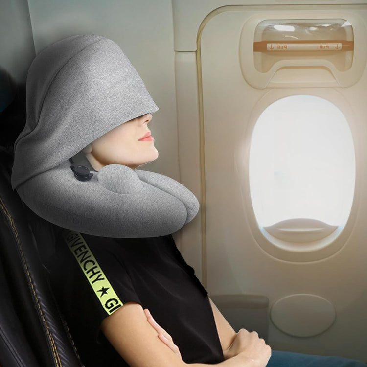Inflatable gray travel pillow with hood supporting neck and head for airplane naps