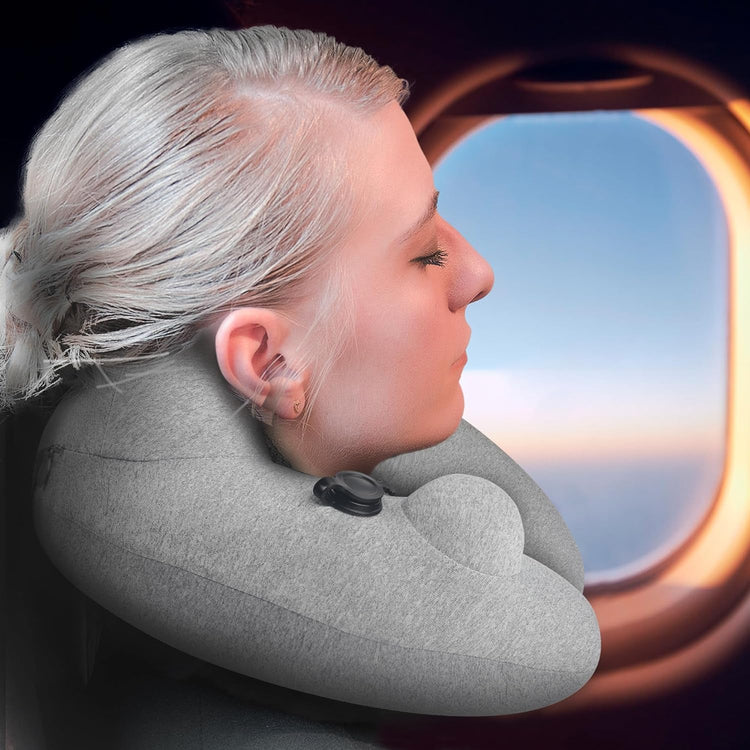 Inflatable travel pillow for airplane with hood providing 360-degree neck support and adjustable softness for comfortable sleep during flights.