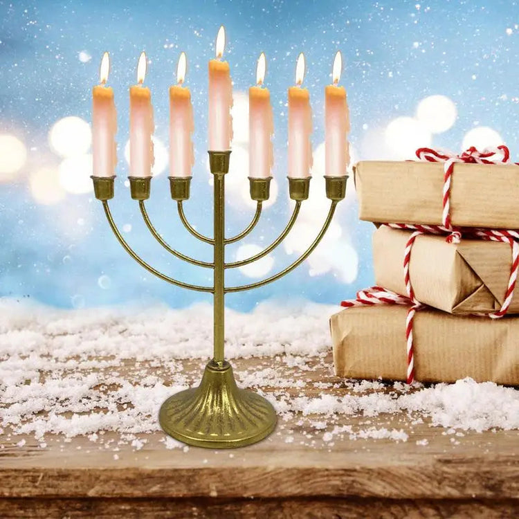 Jewish Candle Holder metal 7-branch menorah with lit candles and holiday gift boxes on wooden surface